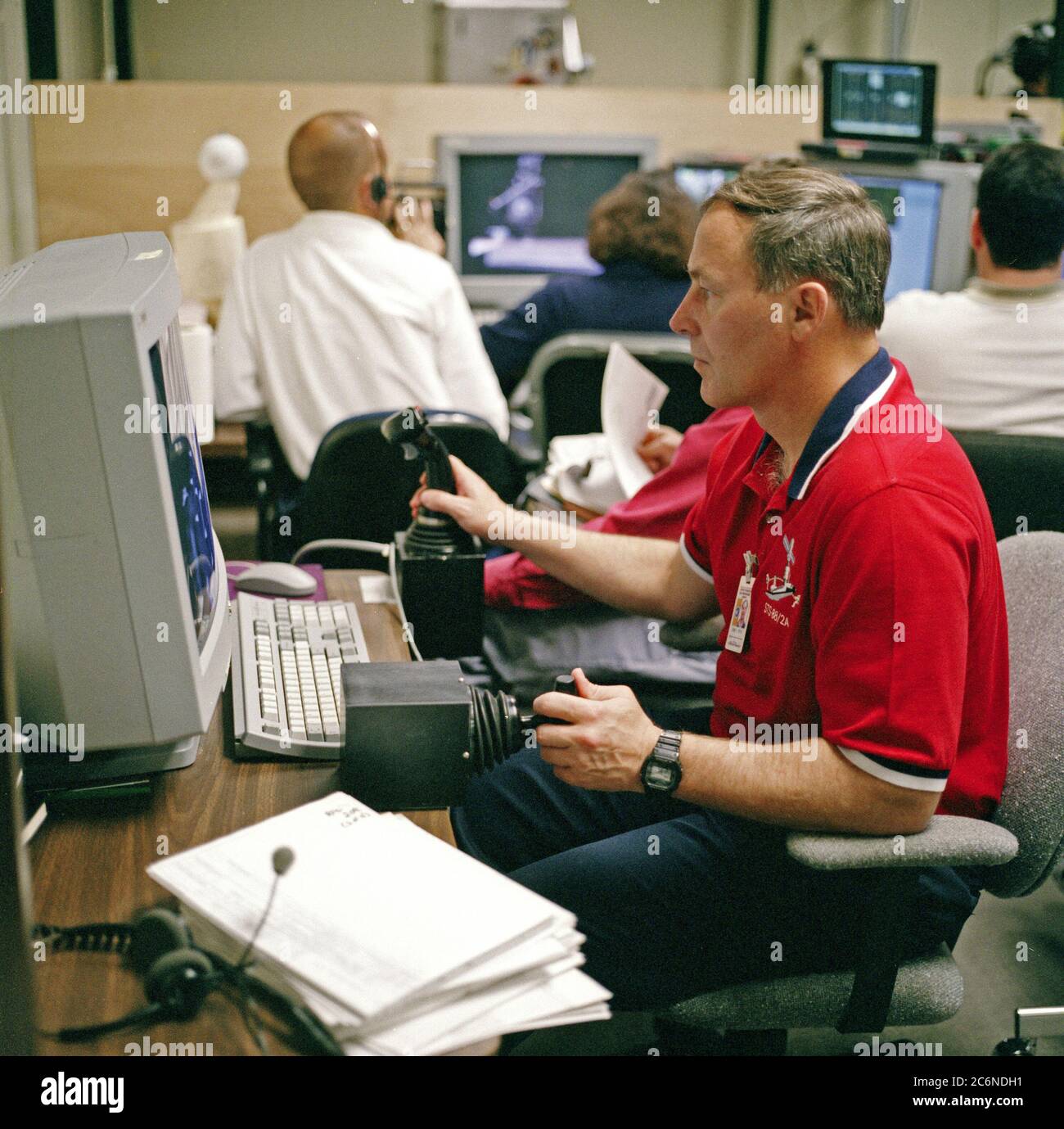 (8 Apr. 1998) --- Astronaut Jerry L. Ross, assigned as a mission specialist for the mission, uses special gear and software to train for his duties aboard the Space Shuttle Endeavour.  This type virtual reality training supplements practice for each of the assigned space-walking astronauts -- Ross and James H. Newman -- during which they wear a helmet and special gloves to look at computer displays simulating actual movements around the various locations on the early International Space Station (ISS) hardware with which they'll be working. Stock Photo