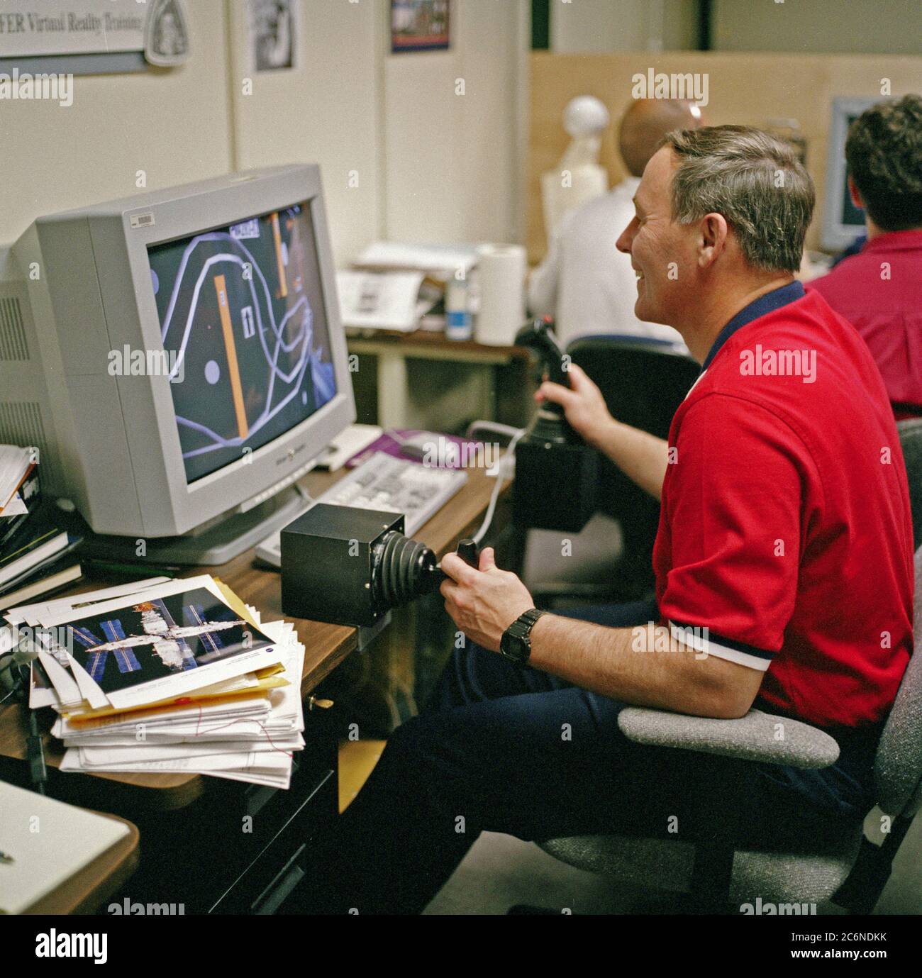 (8 Apr. 1998) --- Astronaut Jerry L. Ross, assigned as a mission specialist for the mission, uses special gear and software to train for his duties aboard the Space Shuttle Endeavour.  This type virtual reality training supplements practice for each of the assigned space-walking astronauts -- Ross and James H. Newman -- during which they wear a helmet and special gloves to look at computer displays simulating actual movements around the various locations on the early International Space Station (ISS) hardware with which they'll be working.  One of those elements will be the Functional Cargo Bl Stock Photo