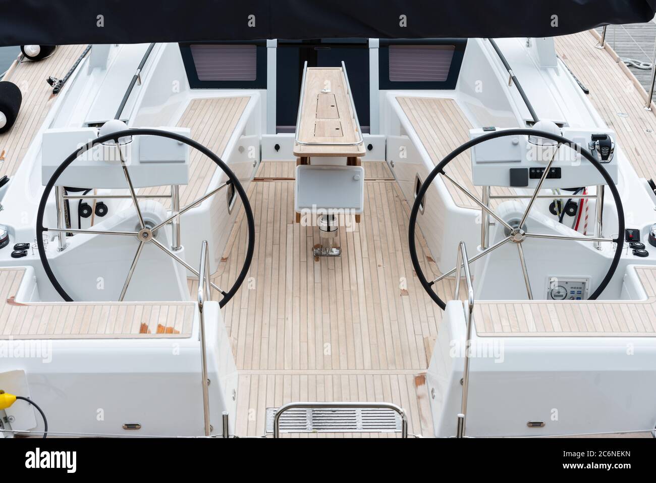 Detail of the steering wheels and symmetry in the deck of a luxury sail yatch. Stock Photo