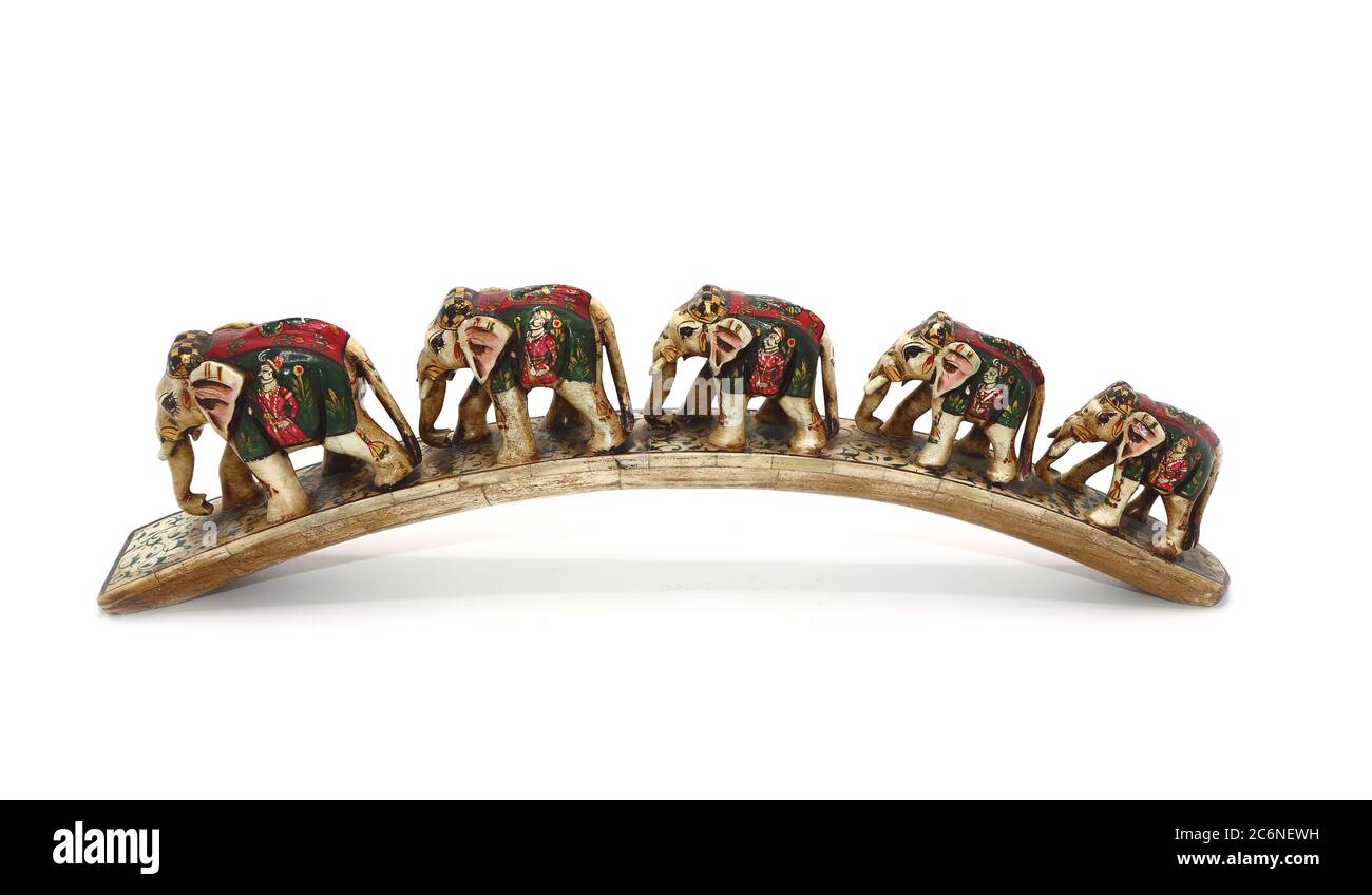 Several elephants on a semicircular stand on a light background. Handmade. Camel bone carving with inlay. India. The work of an unknown master. Stock Photo