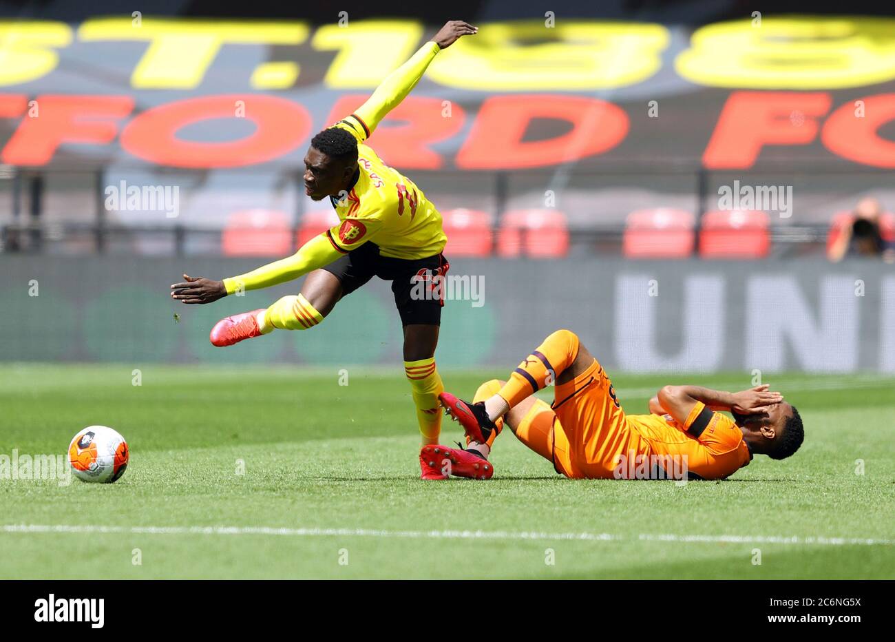 Watford's Ismaila Sarr (left) and Newcastle United's Danny Rose during the Premier League match at Vicarage Road, Watford. Stock Photo