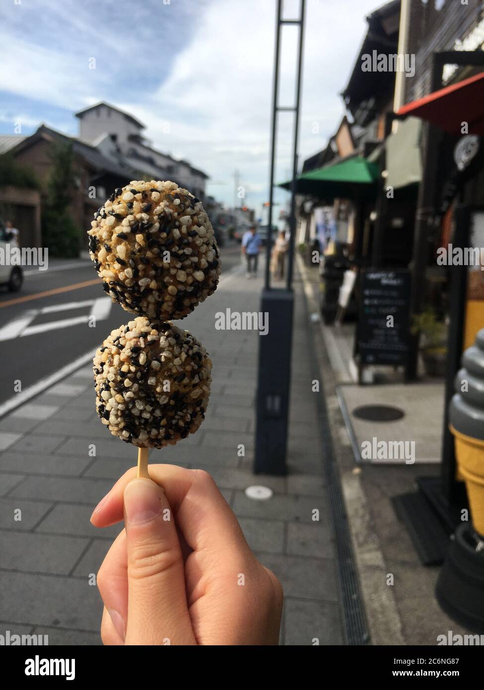 Japanese sweet sesame seed balls on skewer in the streets of historic town of Kawagoe. Summer festival street food, snack. Stock Photo
