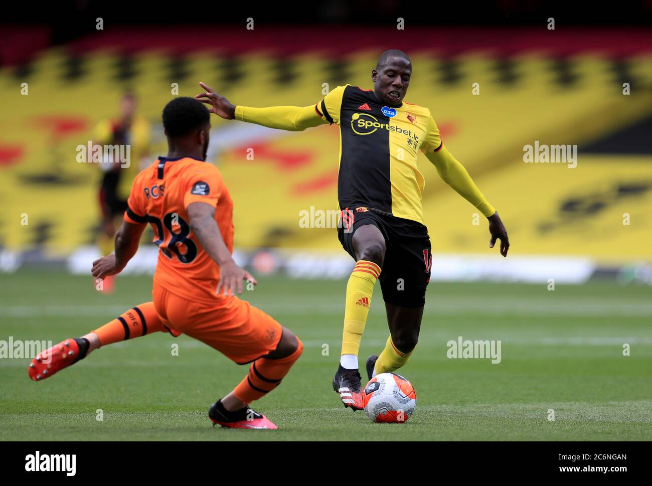 Watford's Abdoulaye Doucoure (right) and Newcastle United's Danny Rose during the Premier League match at Vicarage Road, Watford. Stock Photo