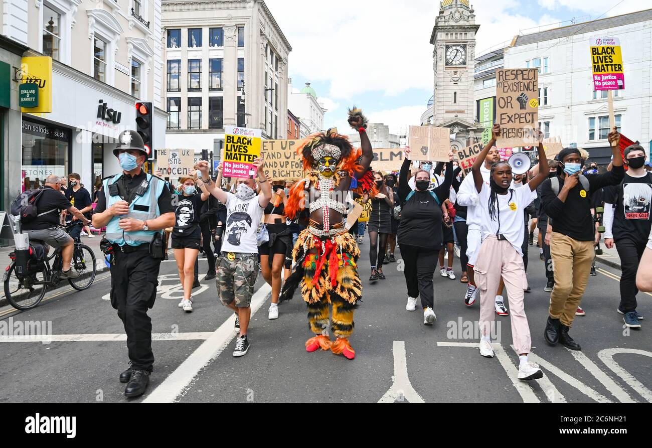 Brighton UK 11th July 2020 - Palaye Seck dressed in traditional  Senegalese costume leads thousands of protesters tin the Black Lives Matter anti racism rally in Brighton today beginning on the seafront before marching through the city centre  . There have been protests throughout America , Britain and other countries since the death of George Floyd while being arrested by police in Minneapolis on May 25th : Credit Simon Dack / Alamy Live News Stock Photo