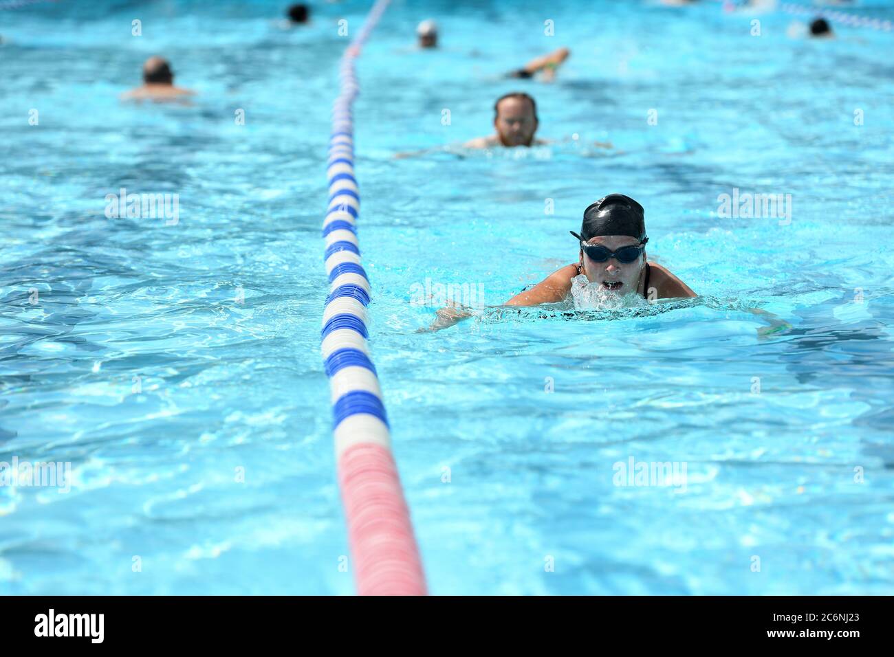 Swimmers at Charlton Lido & Lifestyle Club in Hornfair Park, London. Outdoor swimming pools are reopening to the public on Saturday as the easing of coronavirus lockdown restrictions continues in England. Stock Photo