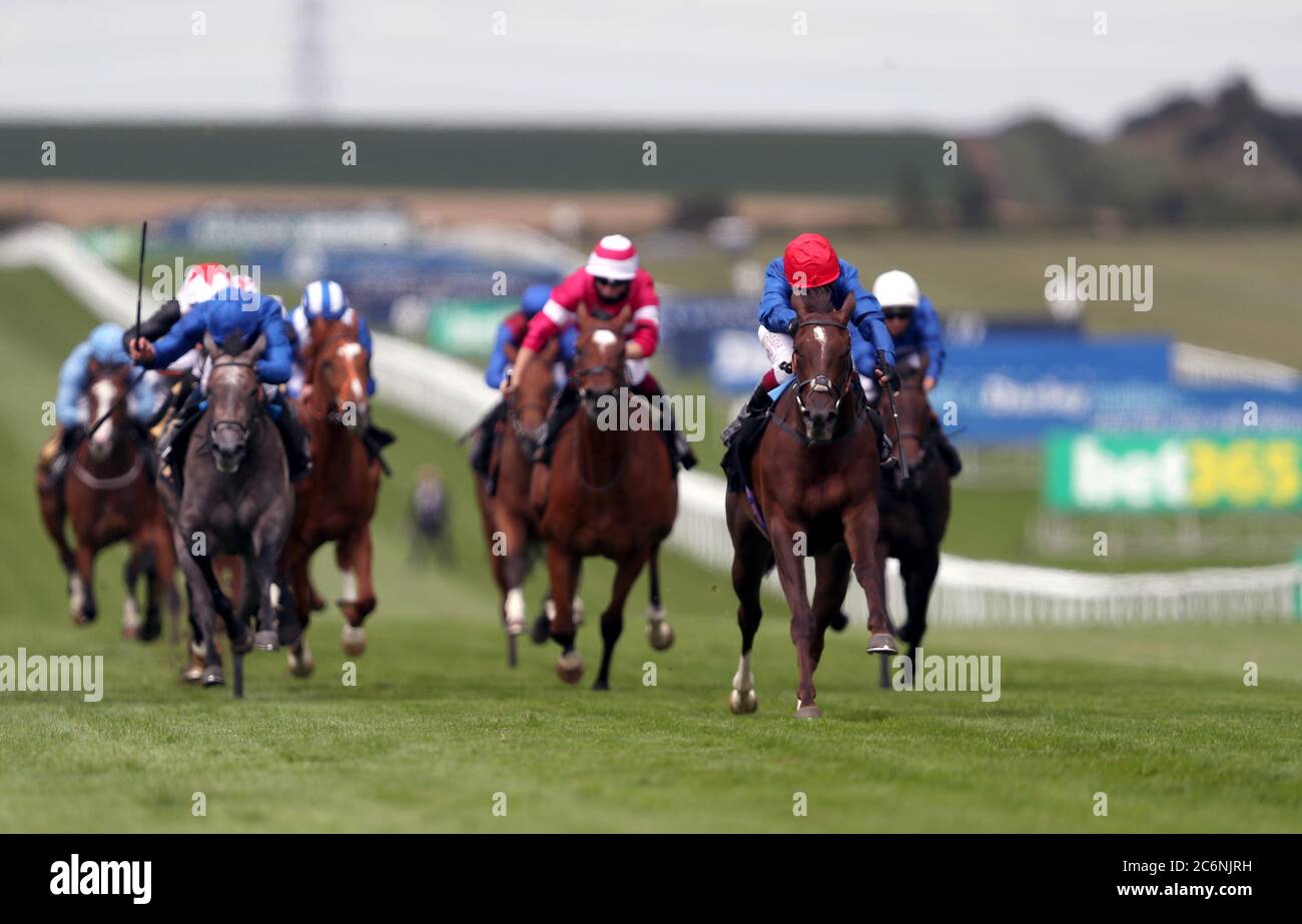 Stunning Beauty ridden by jockey Oisin Murphy (right) win the bet365 Novice Stakes on day three of The Moet and Chandon July Festival at Newmarket Racecourse. Stock Photo