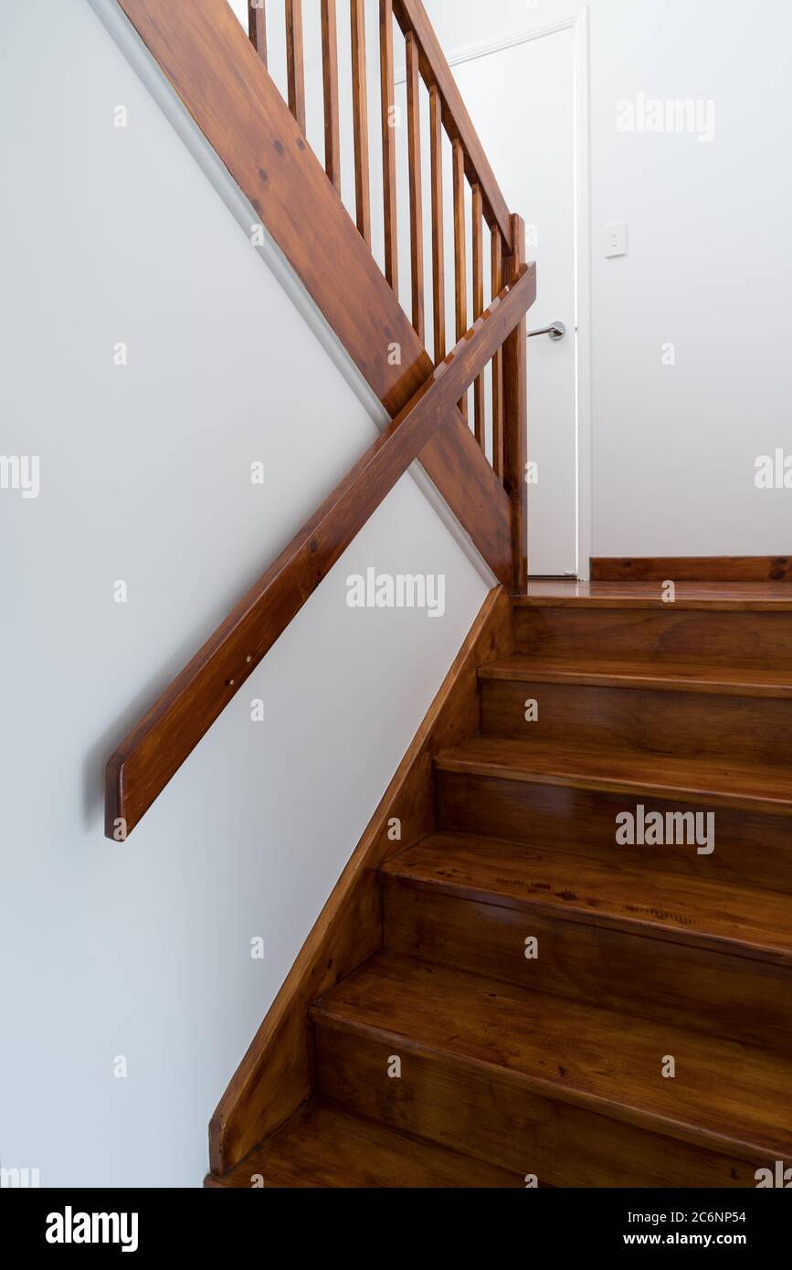 New internal stained timber staircase with hand railings Stock Photo