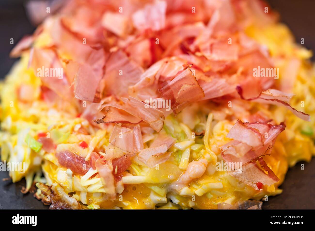 Closeup on an okonomiyaki Japanese omelet, which means cooked to your