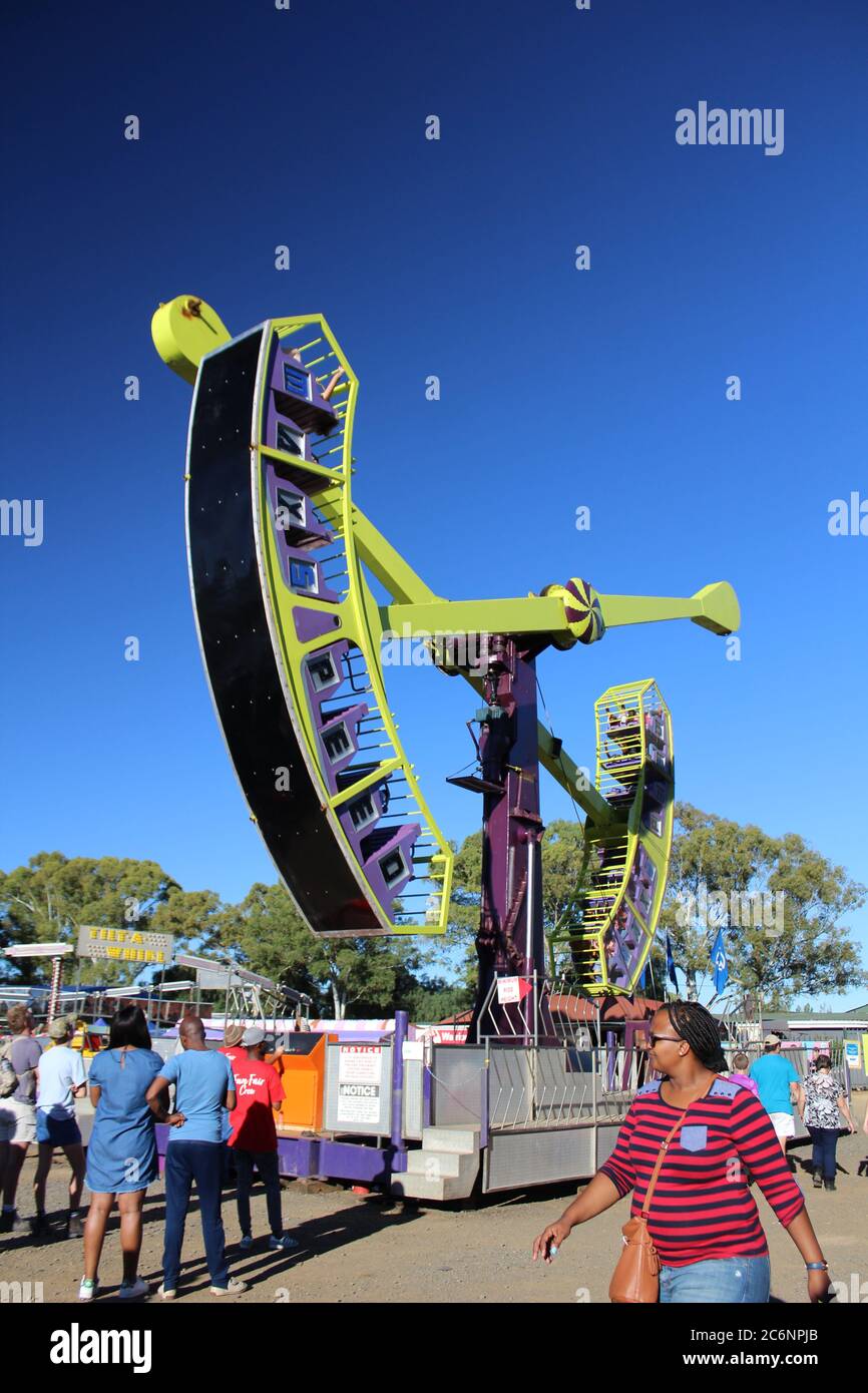 People around Looping Starship in an amusement park Stock Photo