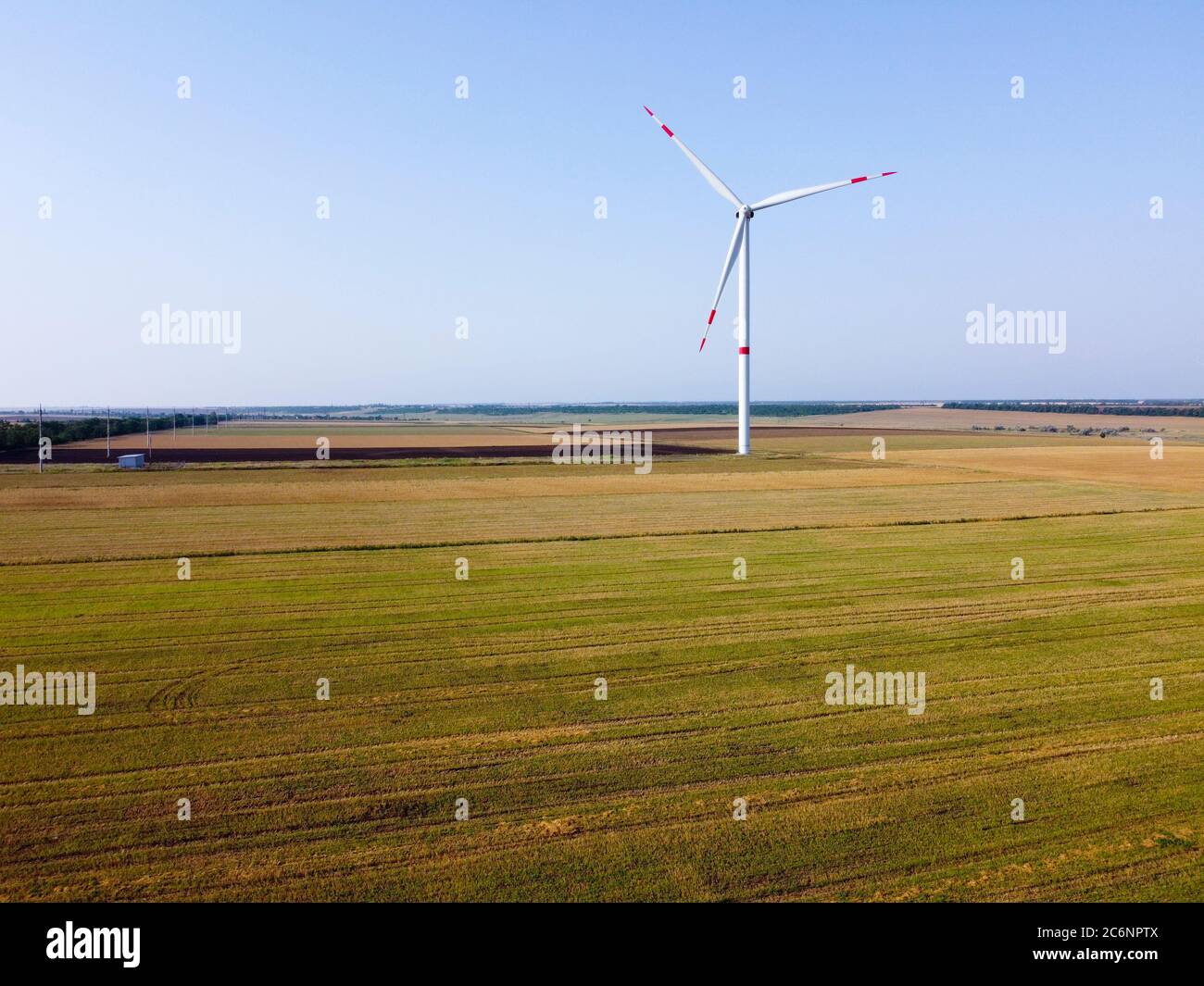Wind power plants stand in the field. Windmill that generates