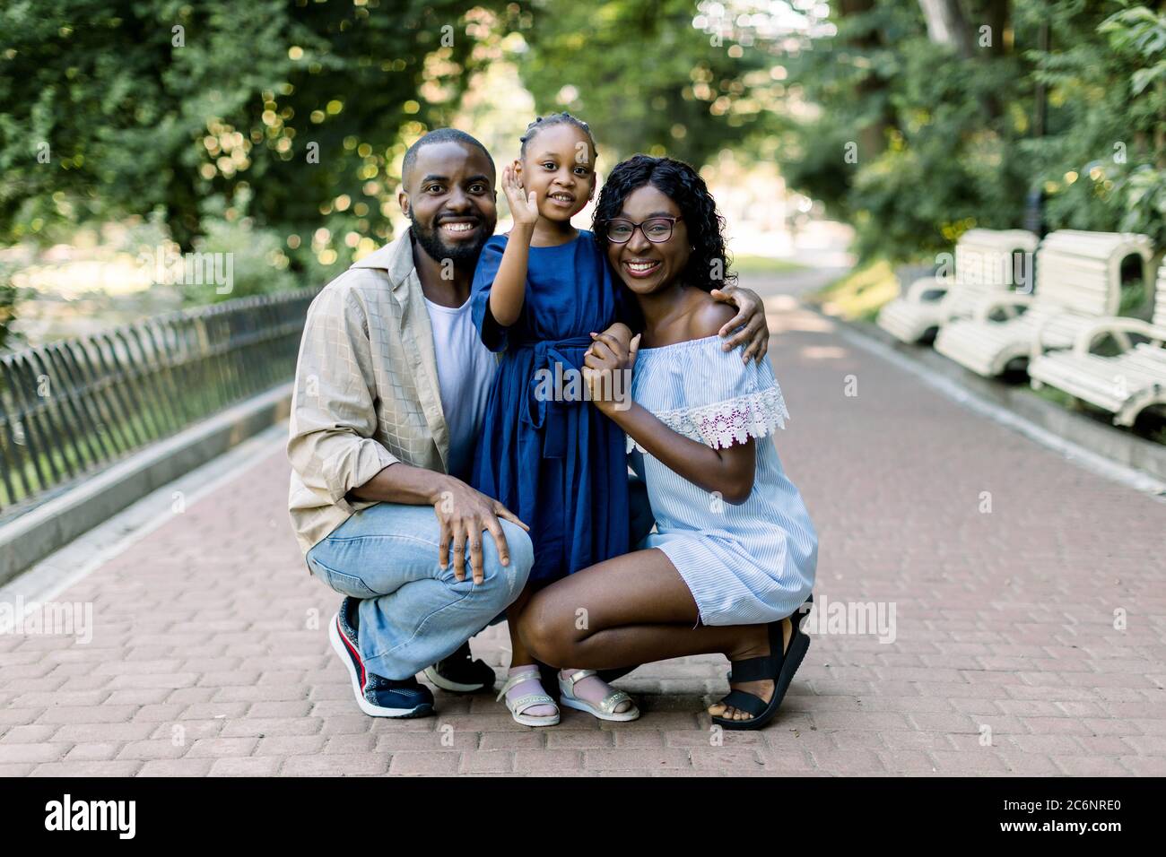 Summer family portrait in nature outdoors. Beautiful young African