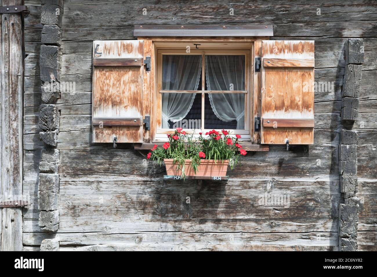 window with shutters and flowers in gray woodhouse Stock Photo - Alamy