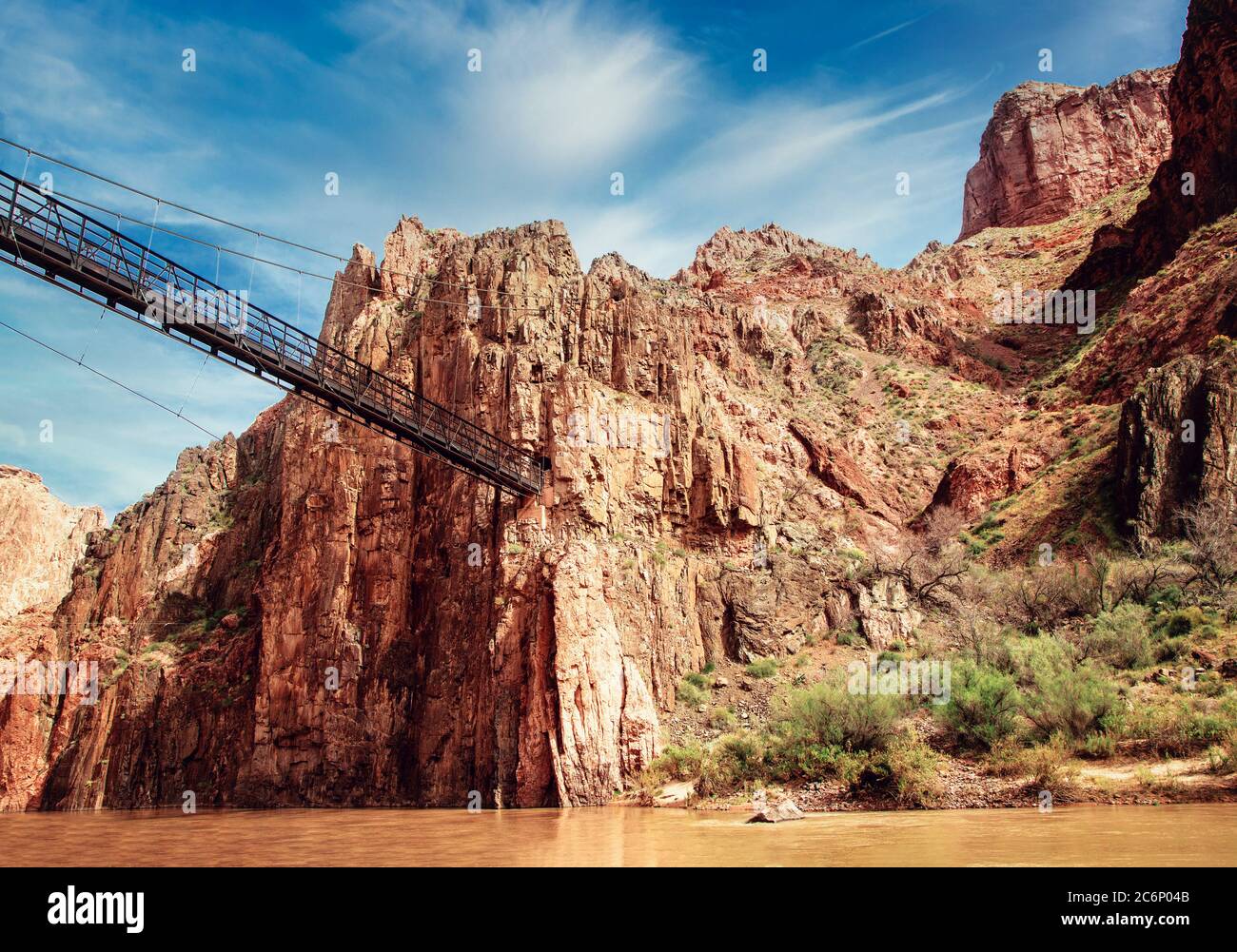 The Kaibab Suspension Bridge or Black Bridge crosses the Colorado River in the Grand Canyon basin near Phantom Ranch in Arizona. Stock Photo