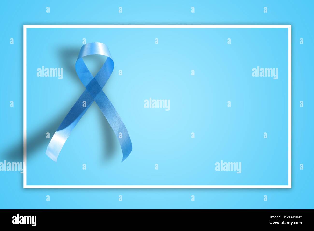 blue ribbon on blue background representing an annual event during the month of November to raise awareness of men's health issues and prostate cancer Stock Photo