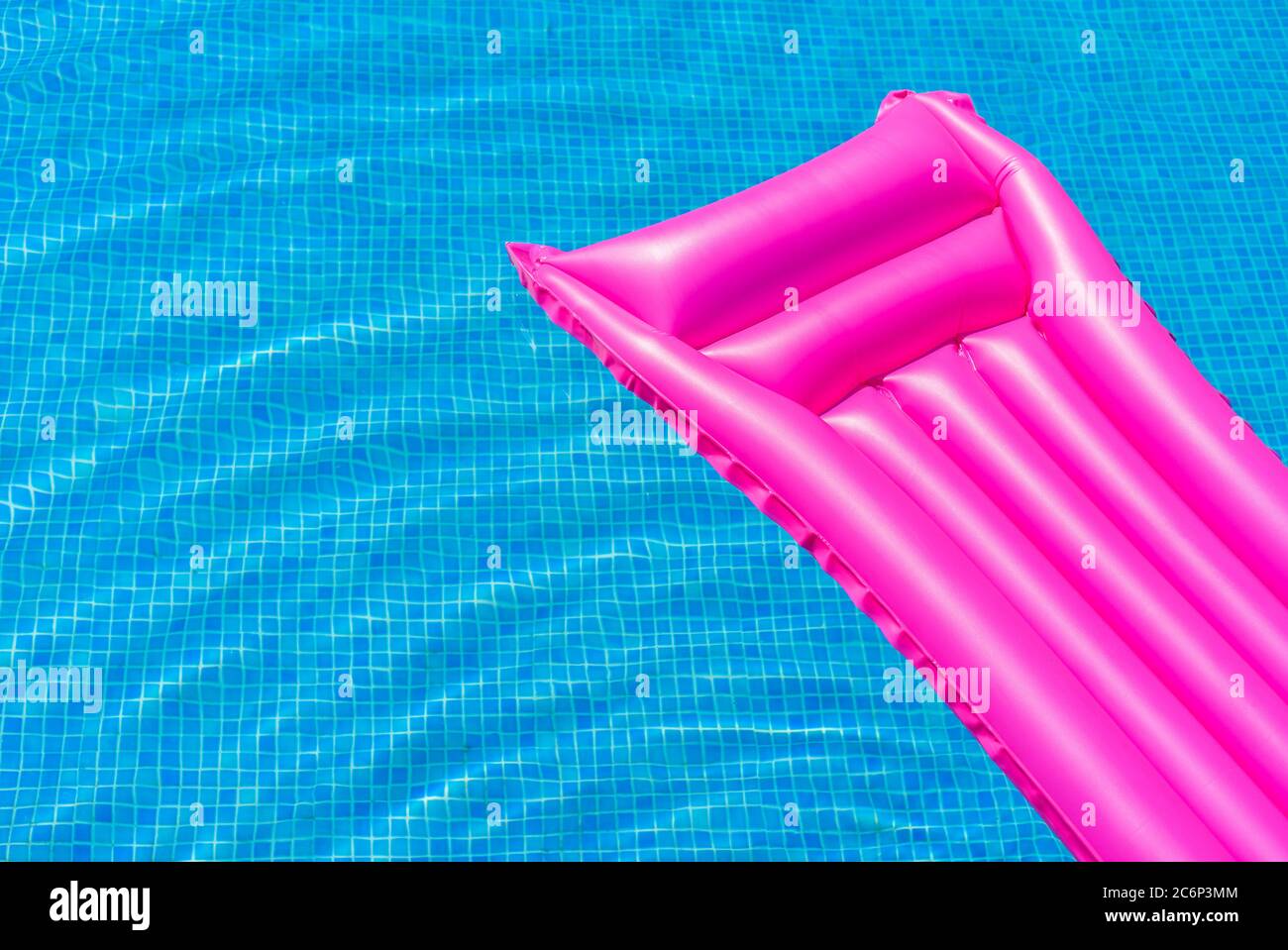 Pink air mattress float on blue swimming pool water Stock Photo Alamy