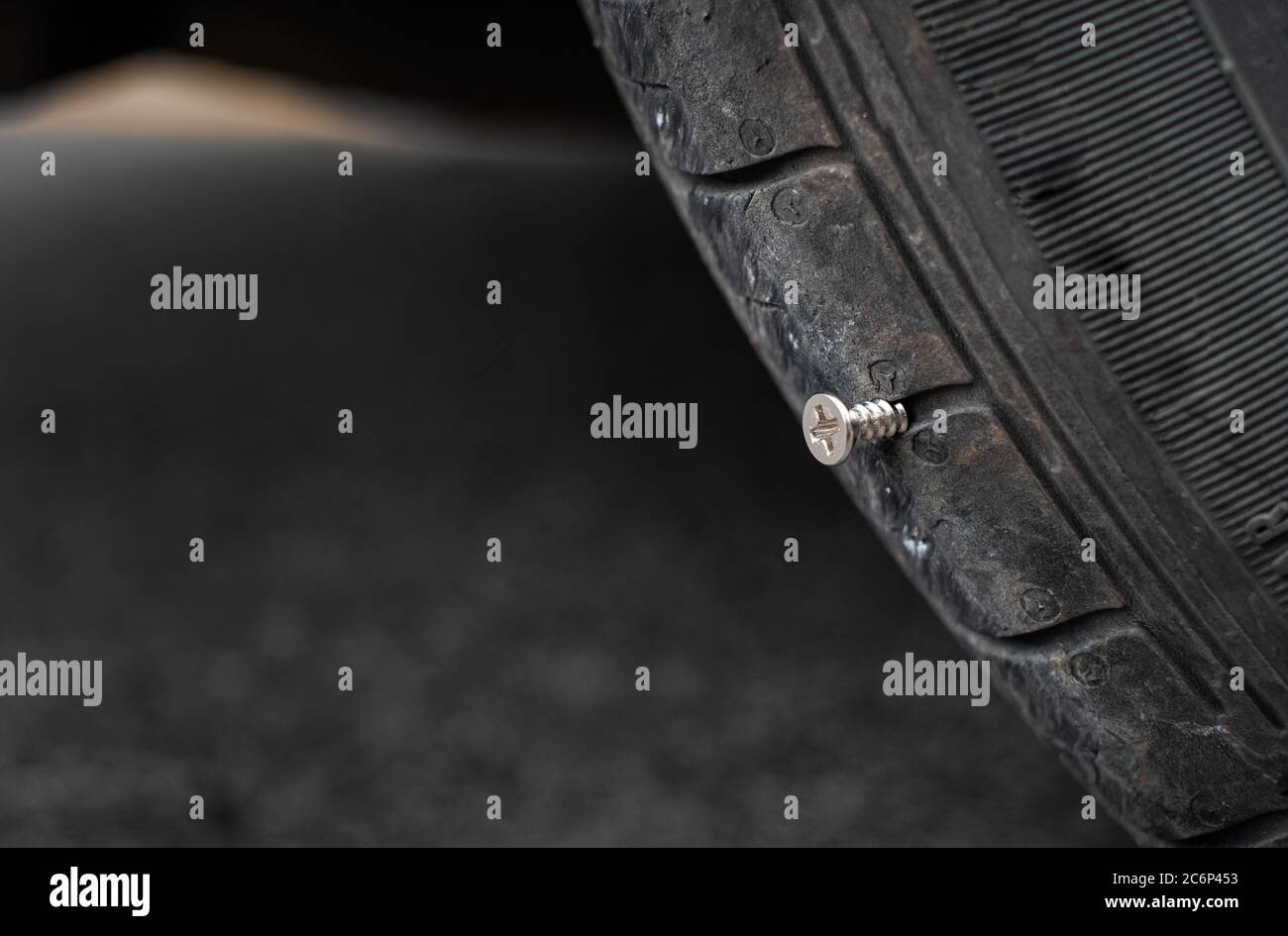 Close up button head needle metal screw nail stuck to puncture into