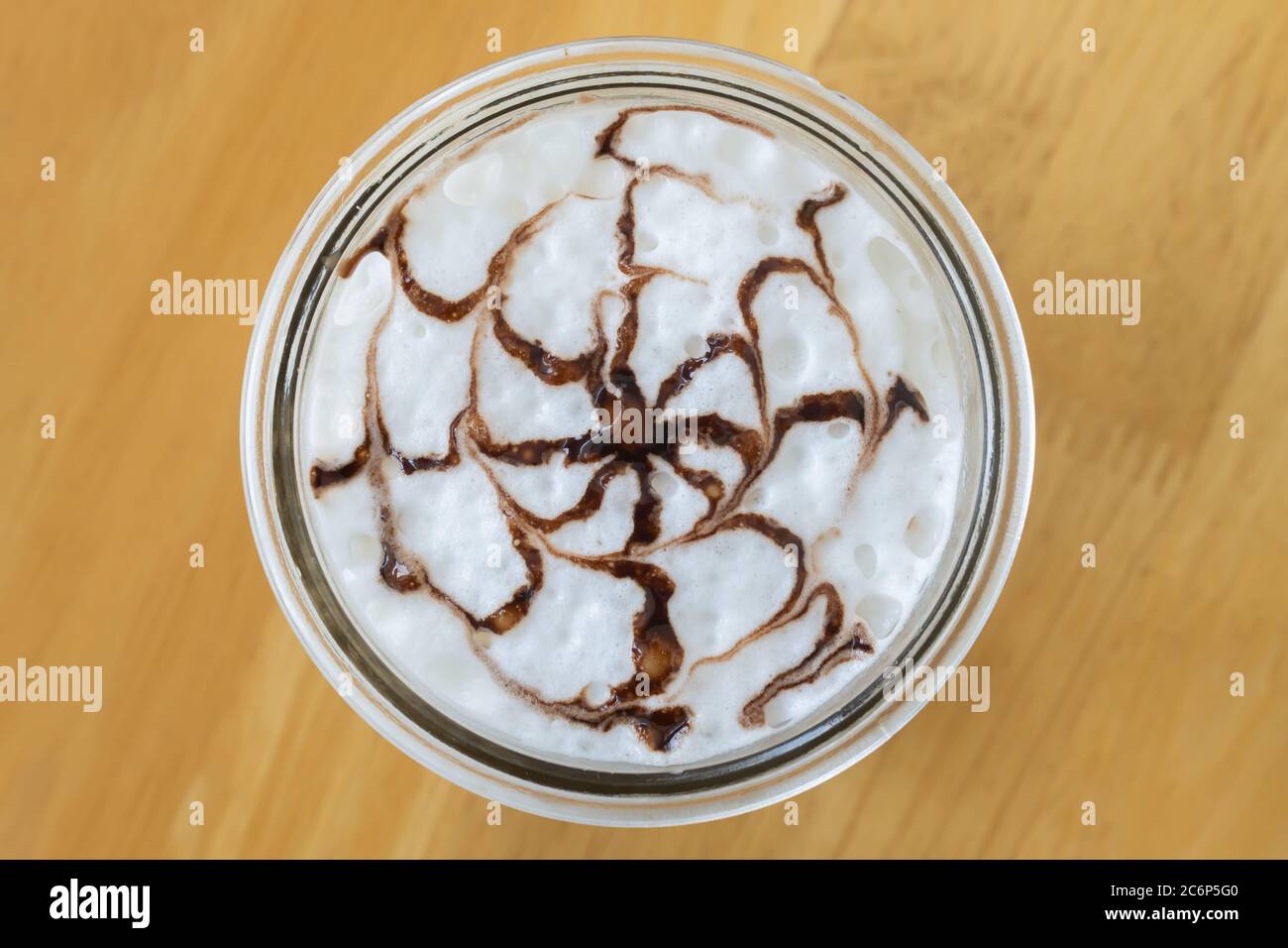 Mocha Coffee and Chocolate Art on Frothing Milk at Center Frame on Wood Background Stock Photo