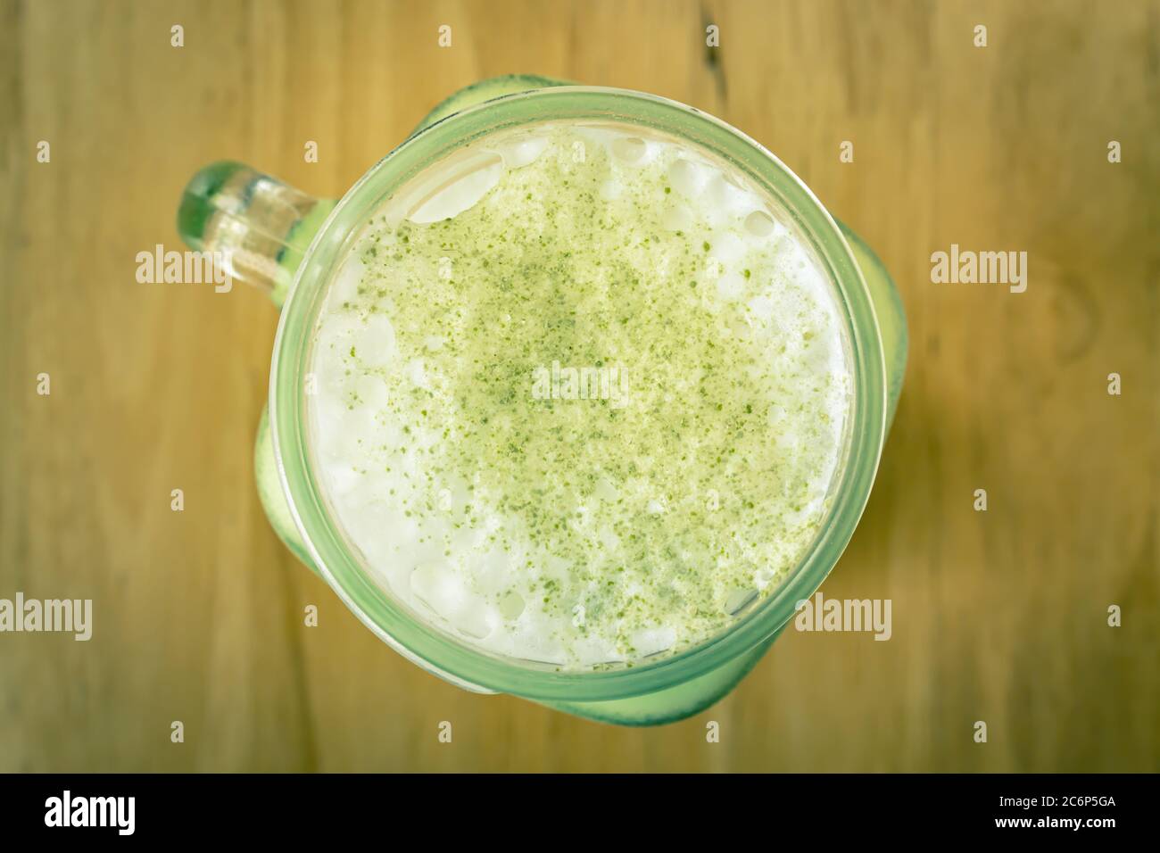 Cold Matcha Green Tea Beverage and Milk Froth and Top View Green Tea Powder Topping in Vintage Tone Stock Photo