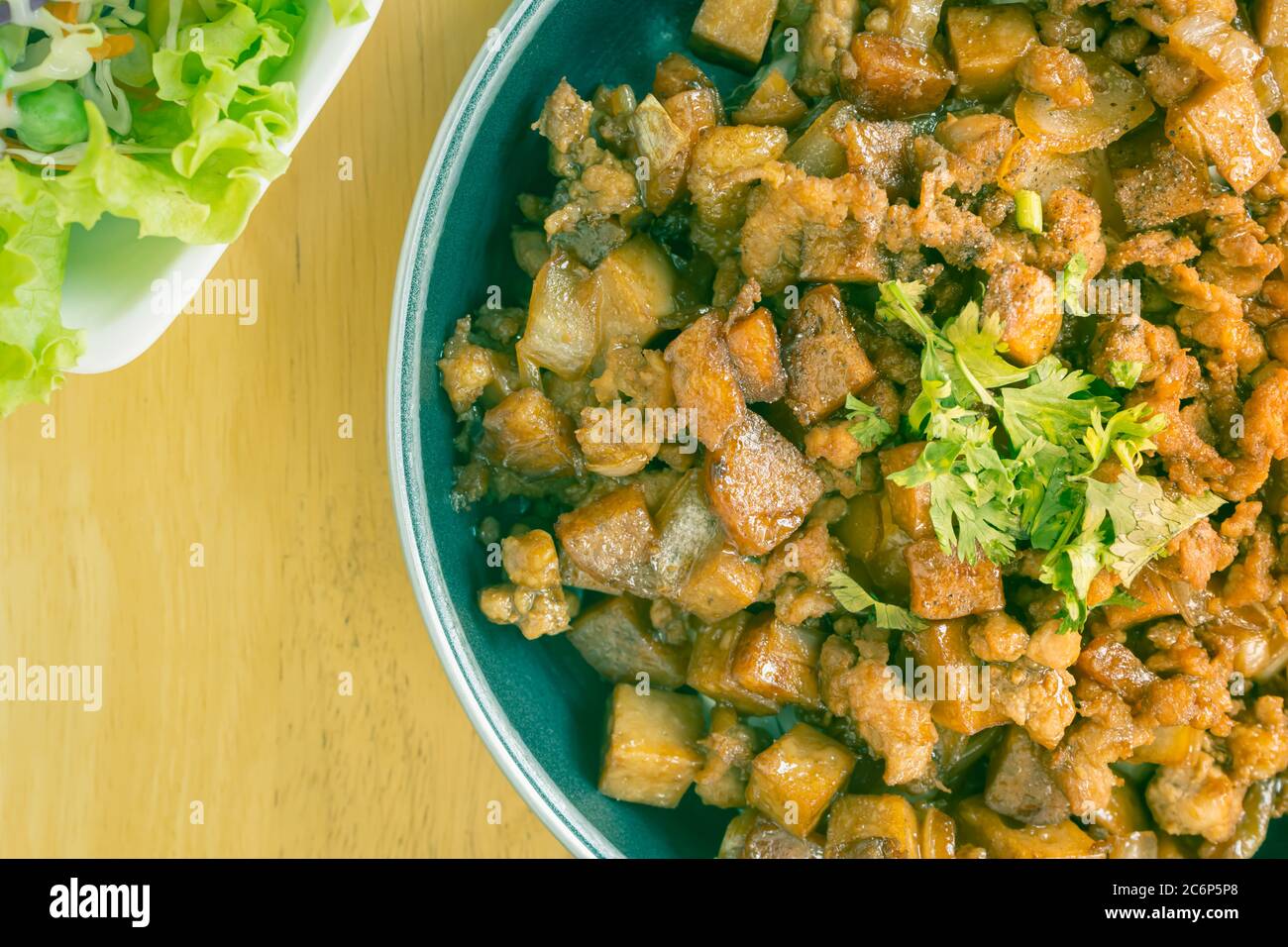 Stir Fried Pork with Onion and Garlic and Black Soy Sauce and Coriander Topping and Tofu with Vegan Salad on Right Frame and Flaylay View in Vintage T Stock Photo