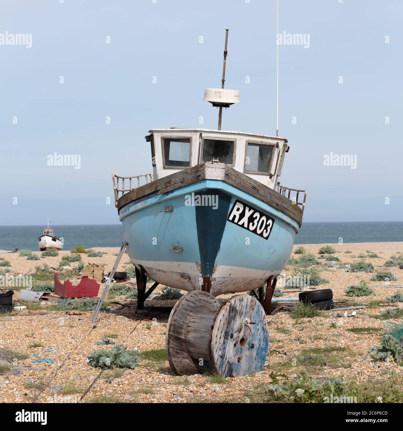 A fishing boat on Dungeness beach, a headland on the coast of Kent ...
