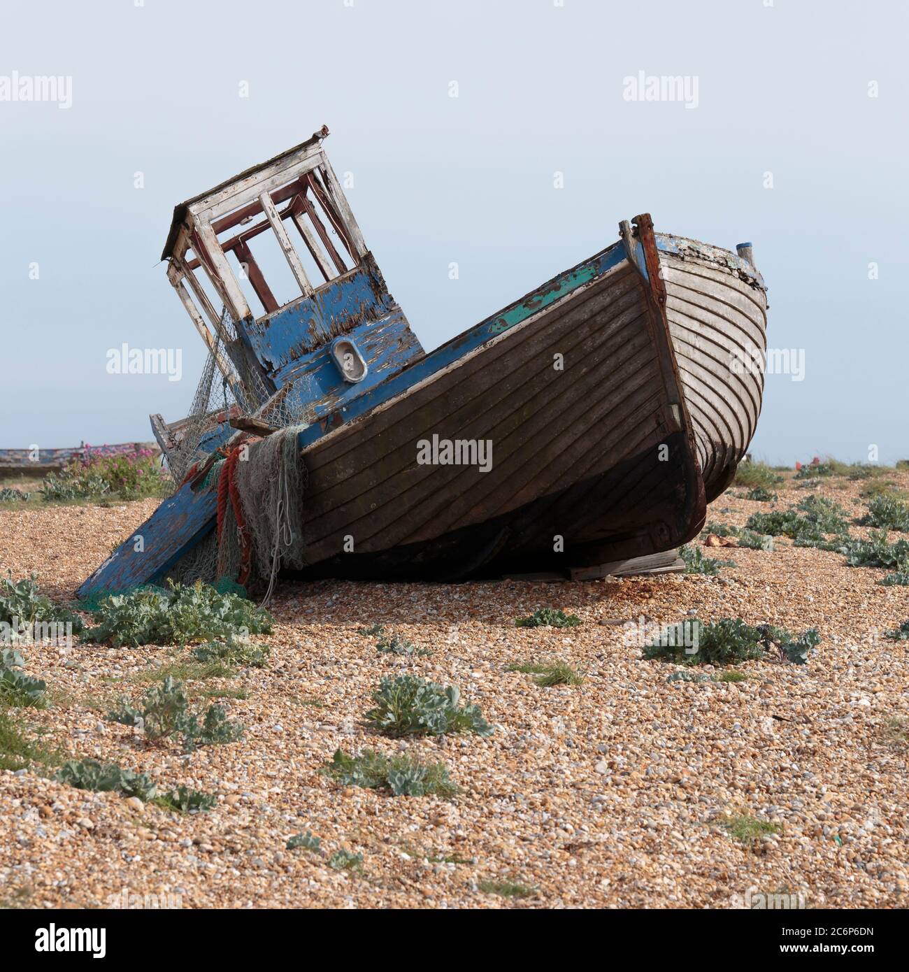 An abandoned fishing boat on Dungeness beach, a headland on the coast ...