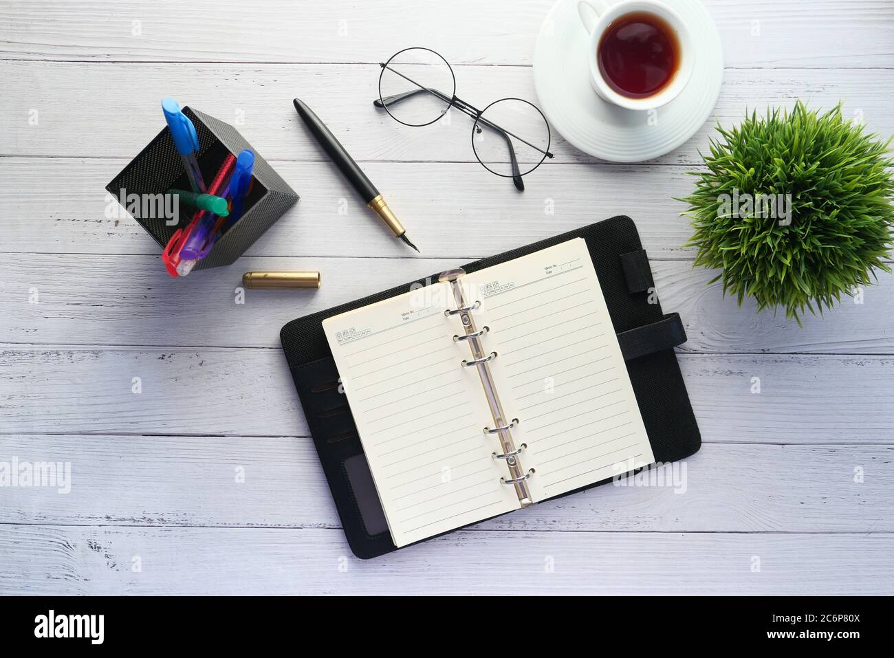 flat composition coffee, notepad and eyeglass on white background . Stock Photo