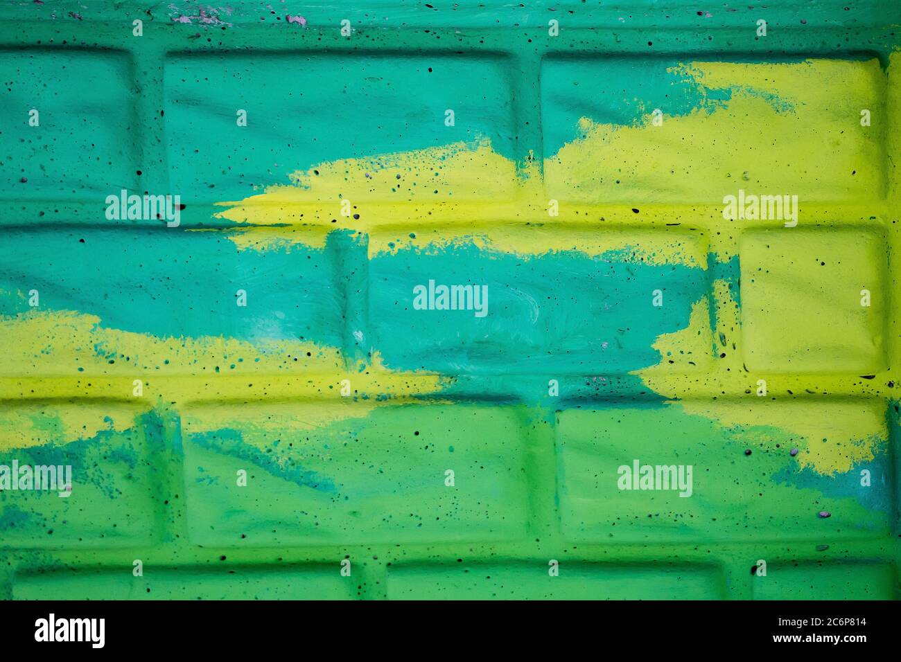 Yellow and green painted brick wall Stock Photo - Alamy