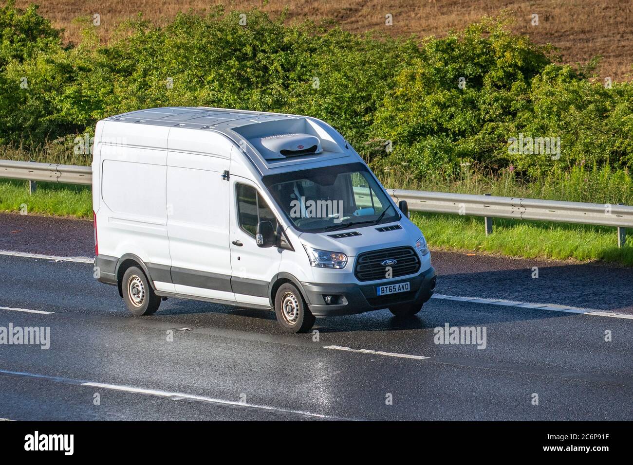 2015 white Ford Transit 350; Haulage delivery trucks, lorry, transportation, truck, panel van cargo carrier, vehicle, European commercial transport industry HGV, M6 at Manchester, UK Stock Photo