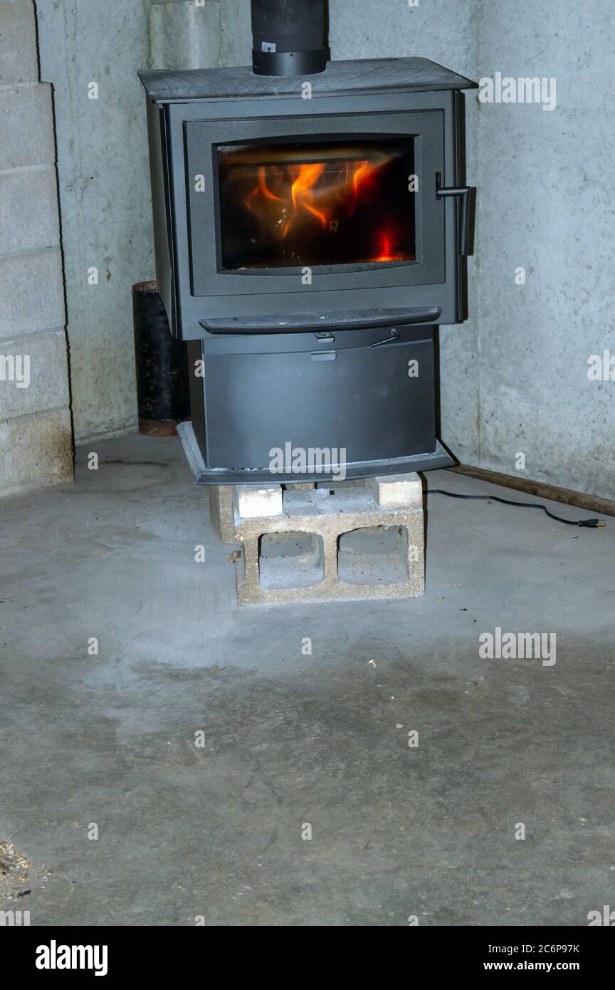 Flames flicker behind the glass in this wood burning stove located in the  basement of a home in Missouri. Just looking at it gives a nice warm  feeling Stock Photo - Alamy