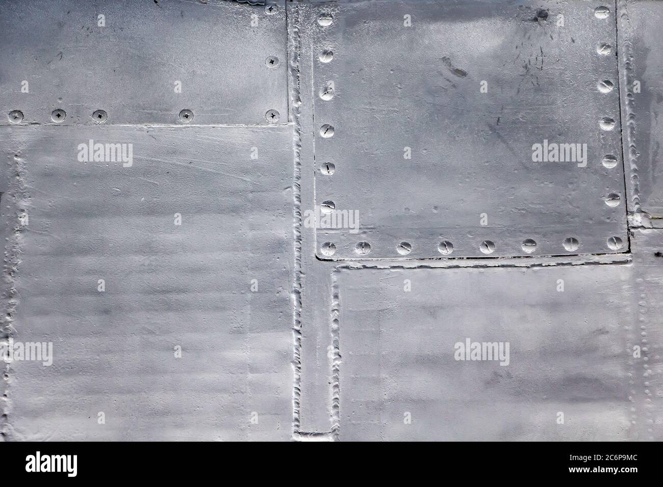 Aircraft skin close up. Rivets on gray metal. Background for design