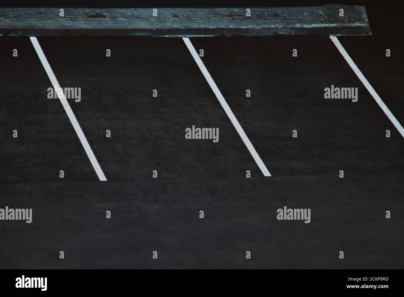 Empty parking during quarantine in the city. White markings for cars on black asphalt. Stock Photo