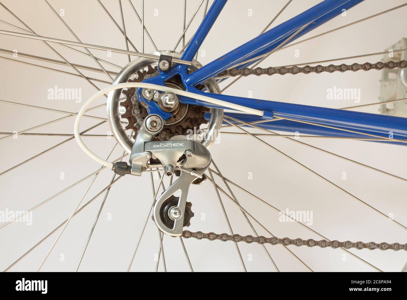 Shimano Exage 500 EX Rear Derailleur, spokes and chain on a sporty bicycle. Close-up image. Stock Photo