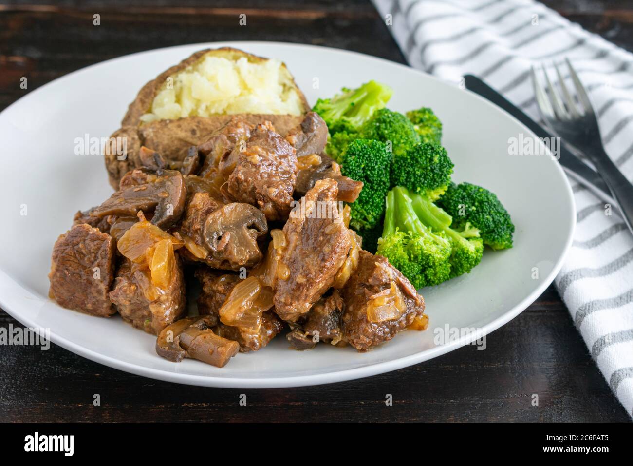 Steak Diane Casserole with Sides Chunks of beef, onion, and mushrooms