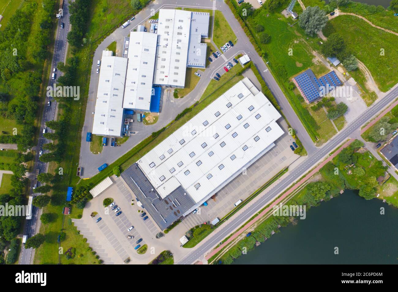Aerial view of modern storage warehouse with solar panels on the roof ...