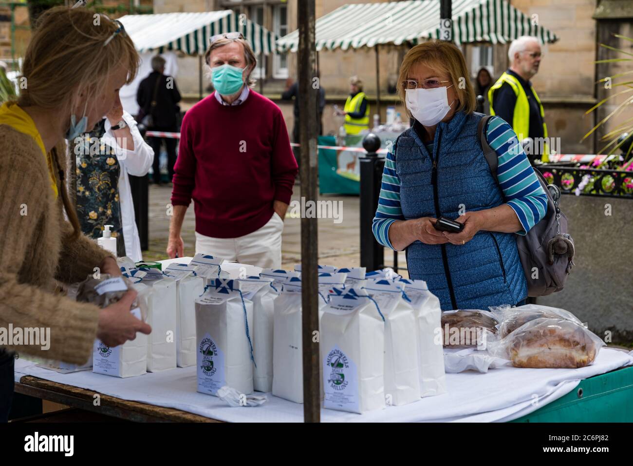 Customers wearing face masks at Farmers Market a Mungoswells flour stall during Covid-19 pandemic, Haddington, East Lothian, Scotland, UK Stock Photo