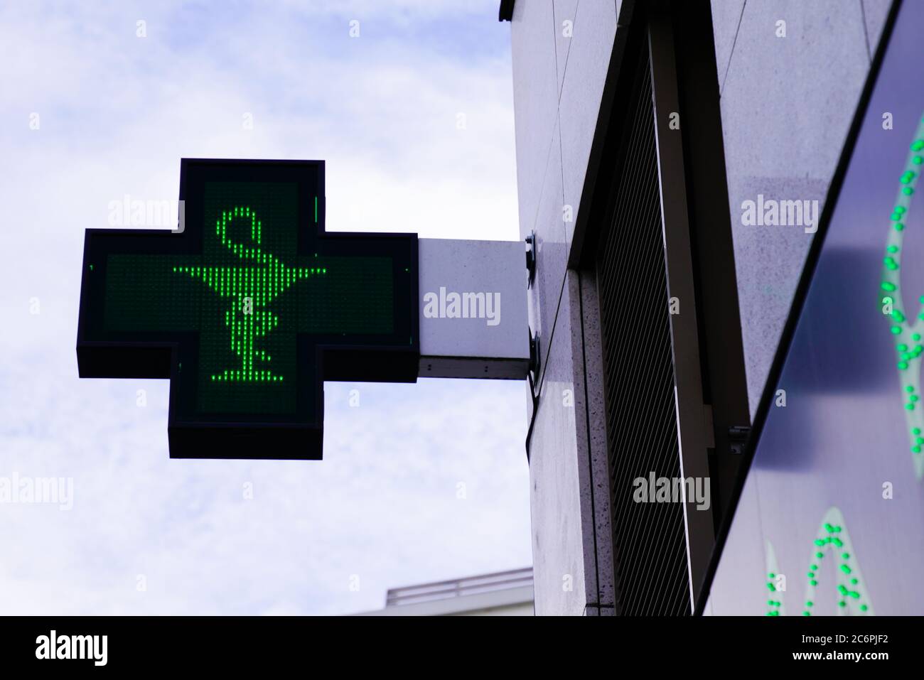green cross Pharmacy sign in street Stock Photo Alamy