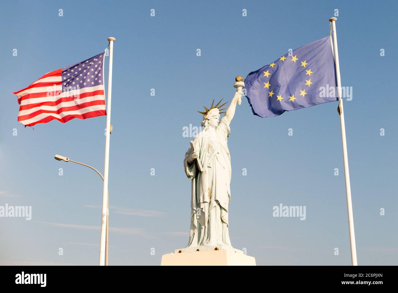 statue of liberty with american flag and european flags in Ellis Island Stock Photo