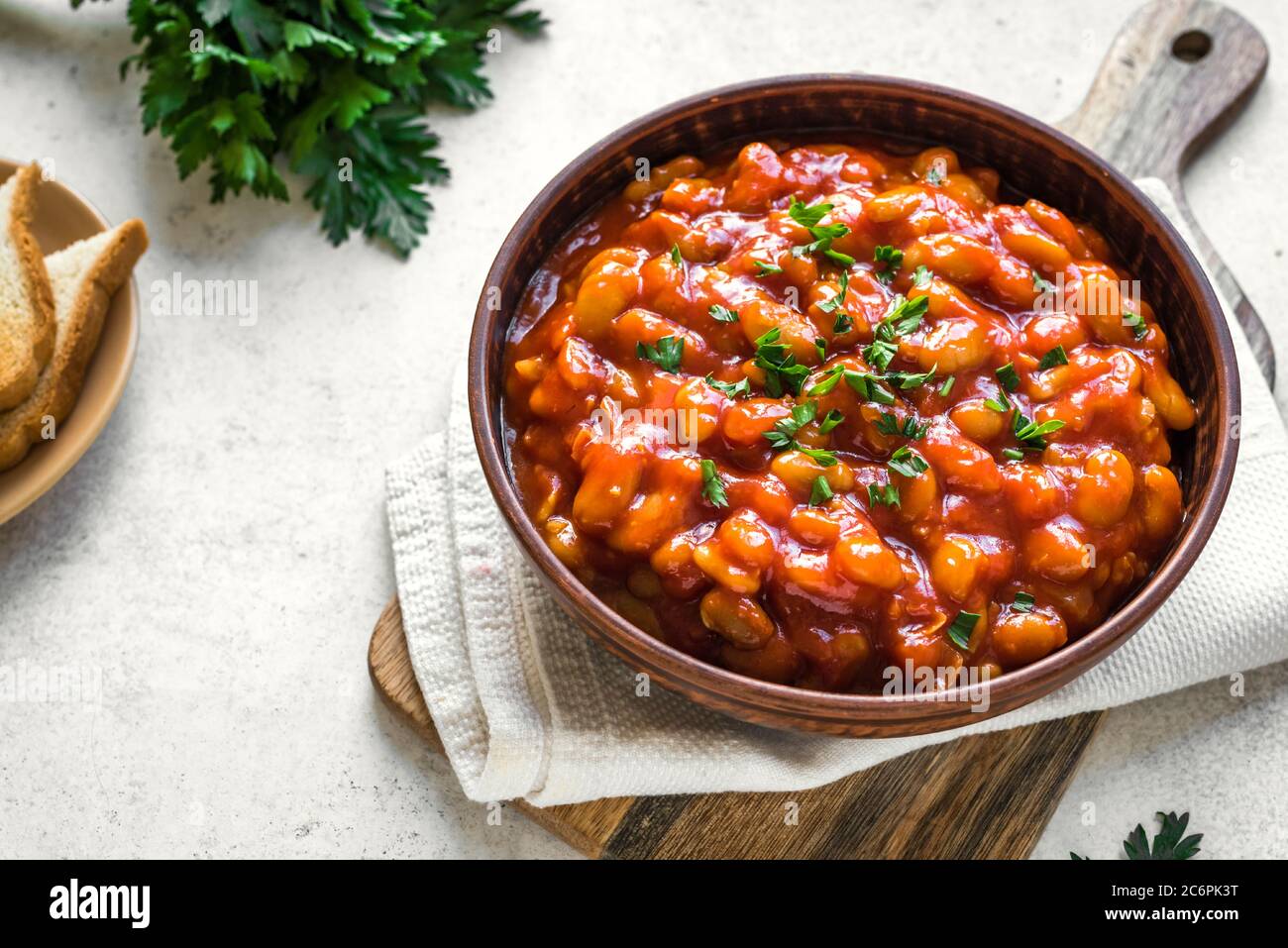 Chili Beans in clay dish, close up. Homemade stewed vegan vegetarian