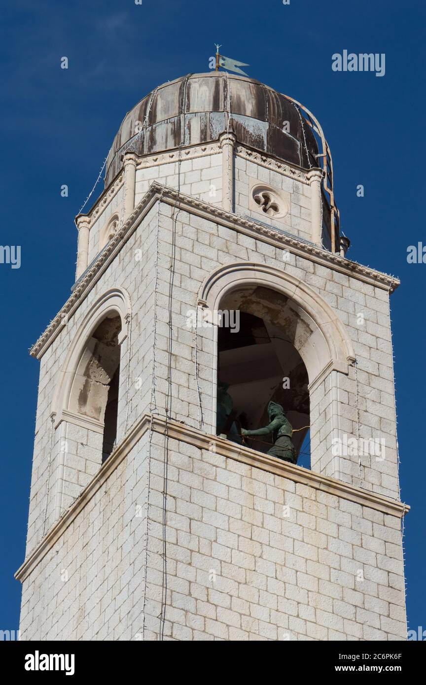 Detail from the city bell tower in Dubrovnik, most iconic landmark in the Old Town. The bell tower contains two characteristic figures Stock Photo