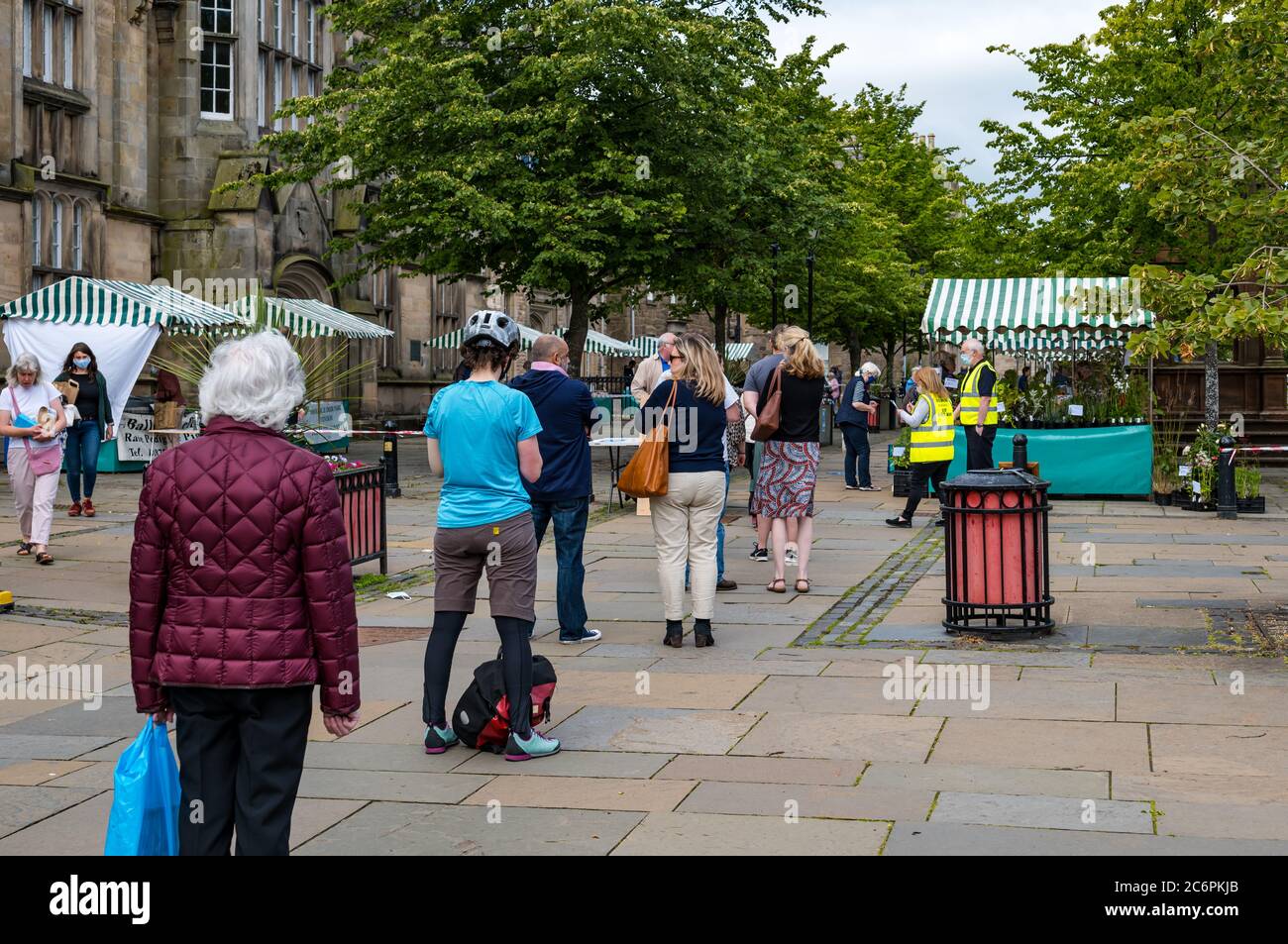 People queueing at re-opening of Farmers Market after lockdown easing during Covid-19 pandemic, Haddington, East Lothian, Scotland, UK Stock Photo