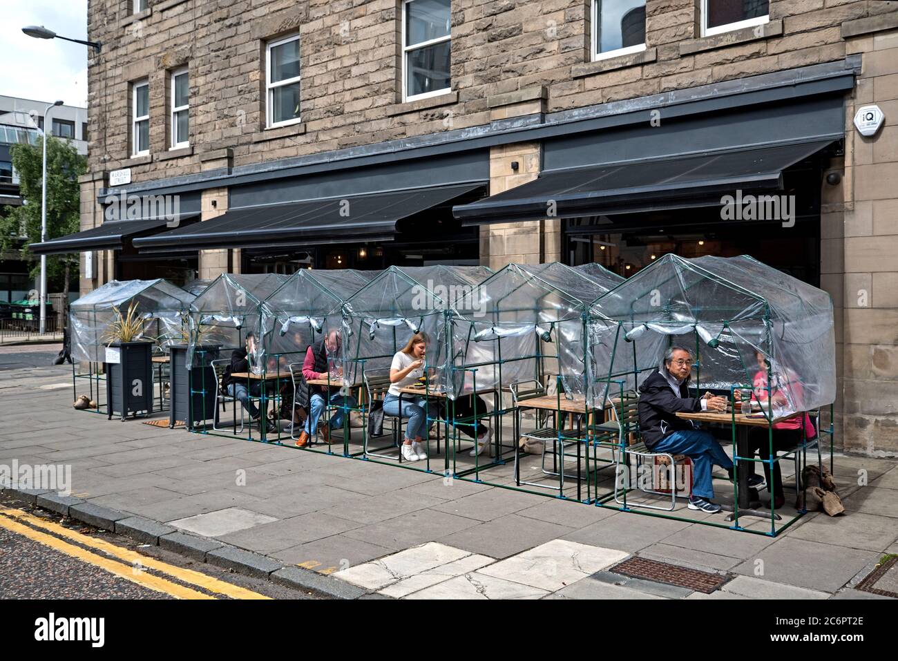 Ransacked Black Oven Restaurant customers dining in temporary greenhouses as restrictions begin to be eased in Scotland during the covid-19 outbreak. Stock Photo