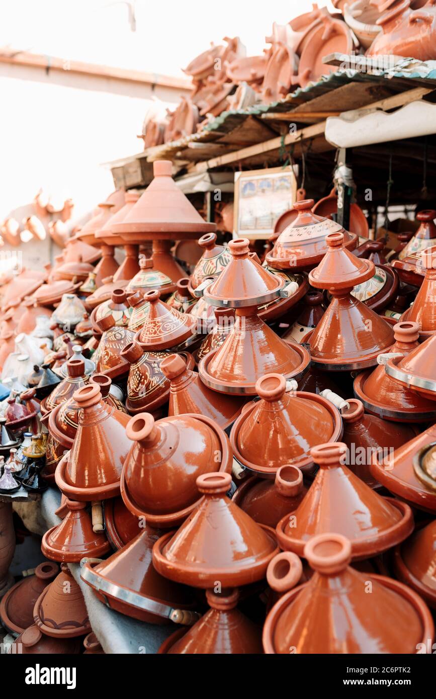 Colorful Moroccan Tajine's, a type of earthenware pot, laid out in a Marrakech Souk or Market, reading to be bought by tourists and locals. Stock Photo