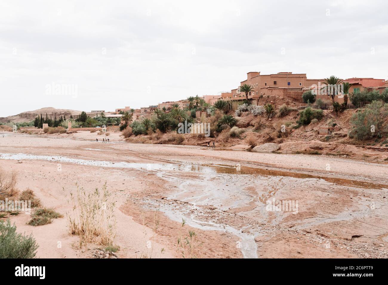 Red Rock Buildings at Ait Ben Haddou, Morocco, Stand Above a Dry Riverbed in the Desert Stock Photo