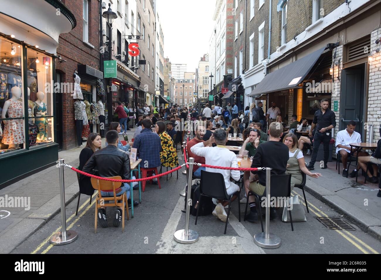 People socialising in Soho, central London, after the lifting of further coronavirus lockdown restrictions in England. Revellers are urged to remember the importance of social distancing as pubs gear up for the second weekend of trade since the lifting of lockdown measures. Stock Photo