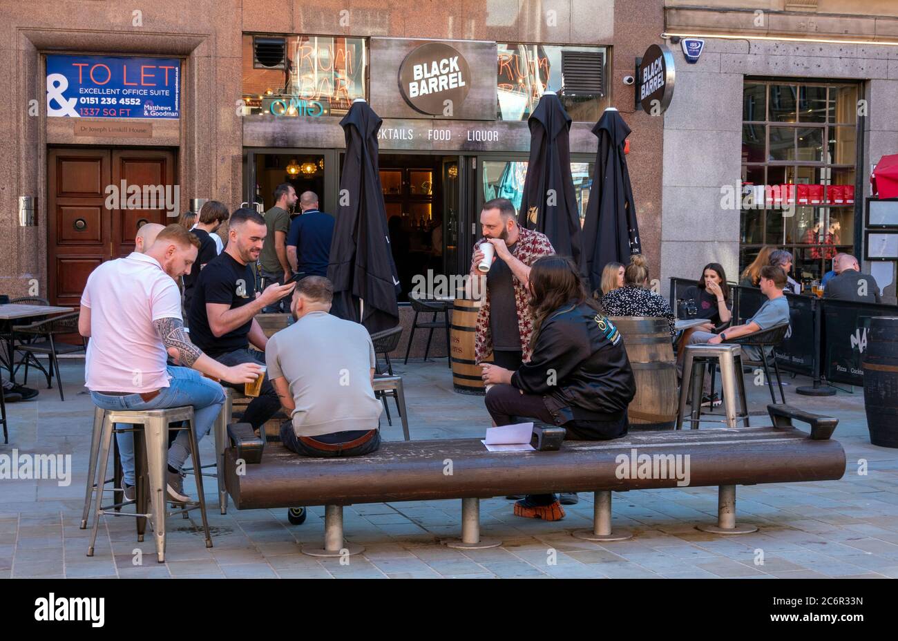 Men having a drink and a talk outside a pub on Castle Street in Liverpool Stock Photo