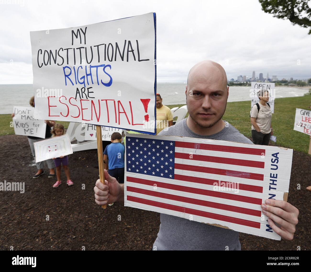 Cleveland, United States. 11th July, 2020. A man holds signs during a protest against Ohio's face covering order in the wake of the Coronavirus (COVID-19) at Edgewater Park in Cleveland, Ohio on Saturday, July 11, 2020. Photo by Aaron Josefczyk/UPI Credit: UPI/Alamy Live News Stock Photo