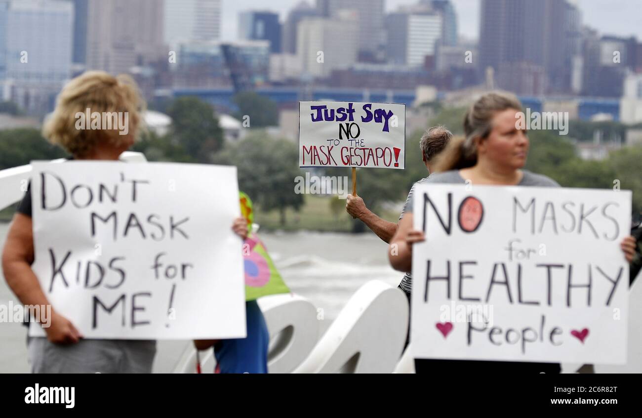 Cleveland, United States. 11th July, 2020. Protestors hold signs during a protest against Ohio's face covering order in the wake of the Coronavirus (COVID-19) at Edgewater Park in Cleveland, Ohio on Saturday, July 11, 2020. Photo by Aaron Josefczyk/UPI Credit: UPI/Alamy Live News Stock Photo