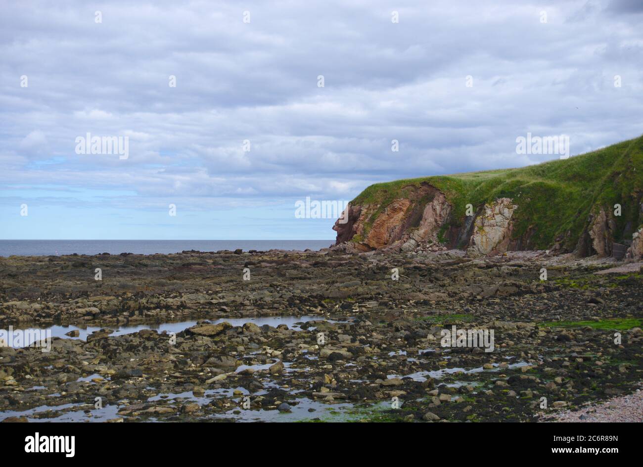 View from Cowdrait (part of Lower Burnmouth, Berwickshire, Scotland) across the rocky shore to the North Sea. Stock Photo