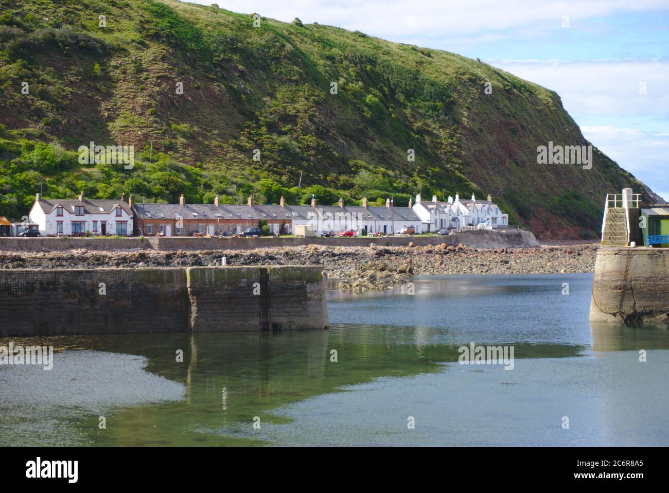 Opening of the harbour at Lower Burnmouth, the southernmost on Scotland's east coast, with Partanhall visible to the north. Stock Photo