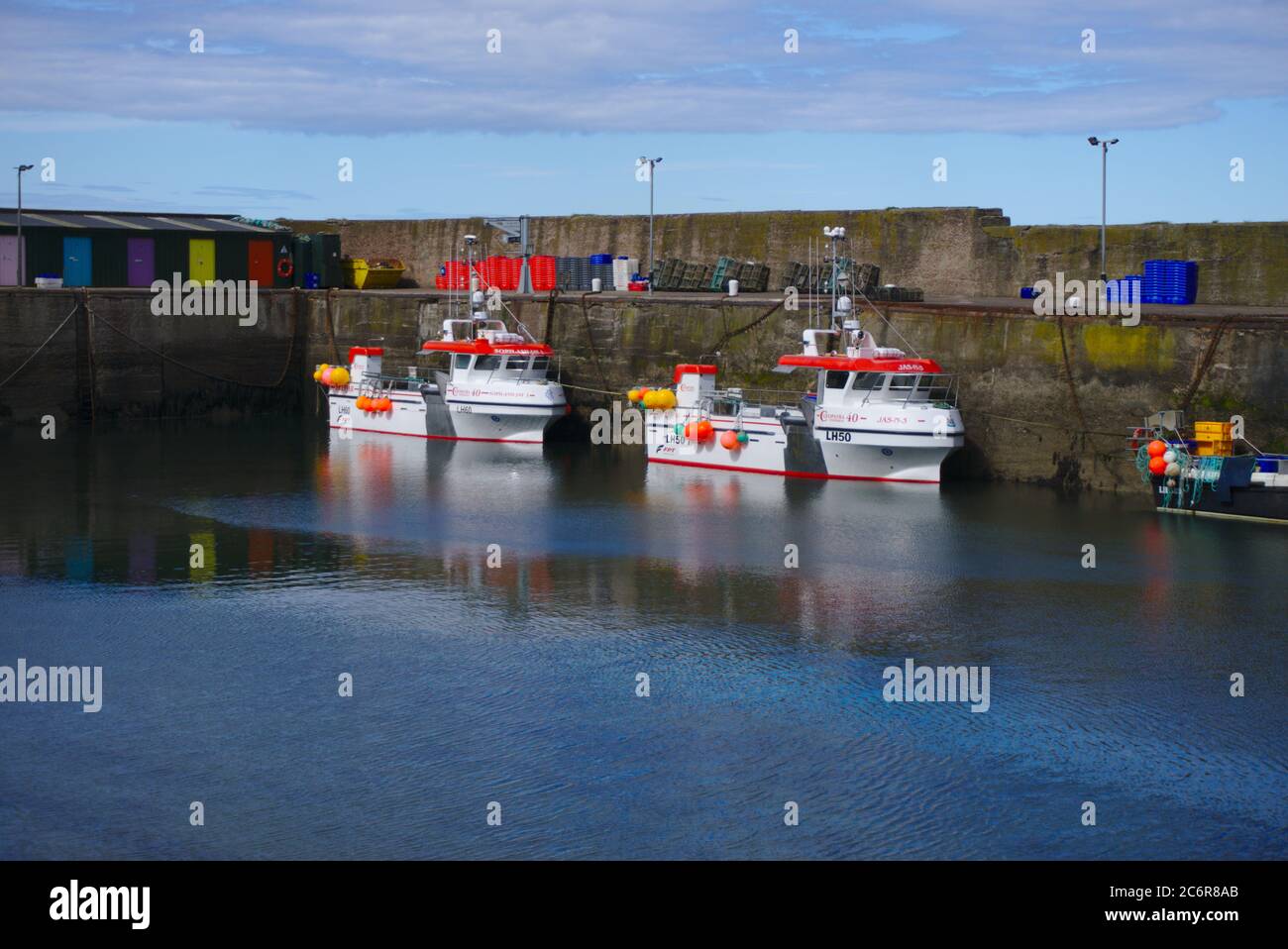 Boats moored at Lower Burnmouth in the southernmost harbour on Scotland's east coast. Stock Photo